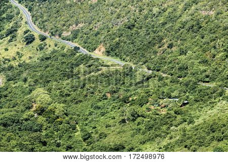 Rural Asphalt Road Winding Through Green Valley