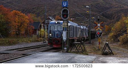 BJORKLIDEN, SWEDEN ON SEPTEMBER 20. An Iron Ore train pass the station on September 20, 2016 in Bjorkliden, Sweden. The train slow down around the station. Editorial use.