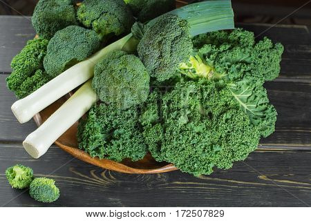 Green winter fresh organic superfood - Kale green cabbage broccoli and leeks prei