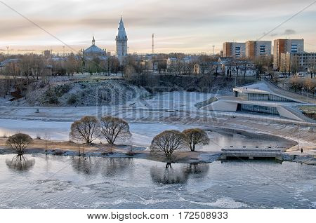Narva. Estonia. View of the city with beach on Narova River and Alexander Lutheran Cathedral