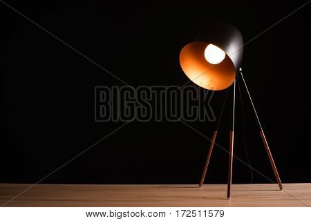 Desk lamp on empty wooden office table as space for text or product placement