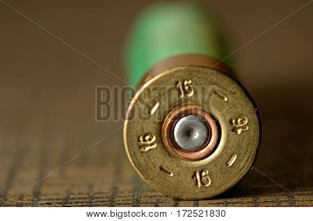 hunting cartridges for shotgun 16 caliber isolated on wooden background