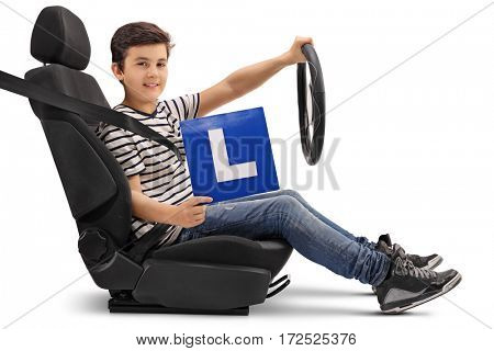 Boy sitting in a car seat and showing an L-sign isolated on white background