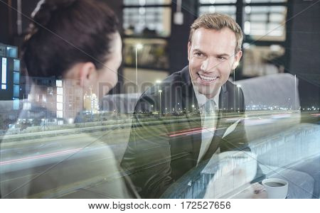 Businessman and businesswoman having a discussion during breaktime in office