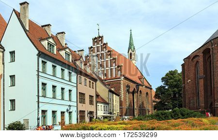 RIGA/ LATVIA - JULY 25, 2015: Old houses on the street Skarnu at the foot of St. Peter's Church. Riga Latvia.