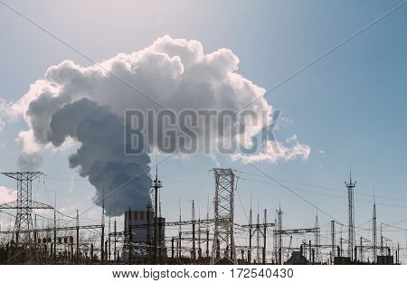 Clouds of thick smoke NPP Nuclear Power Plant in rays of bright sunlight