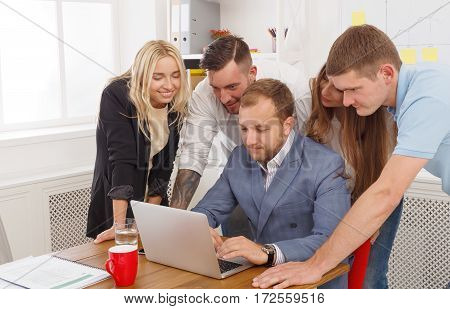 Choosing internet digital marketing strategy for company. Colleagues and coworkers look at laptop. Work and create together. Teamwork in modern digital business concept