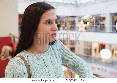 Portrait of the serious girl in shopping center