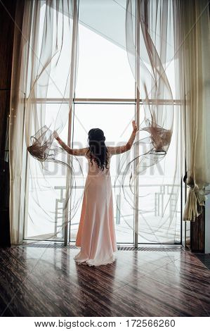 Beautiful Woman Opens The Curtains In The House