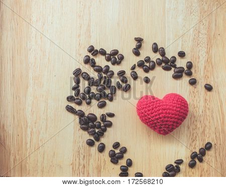 coffee bean and heart symbol on wood background