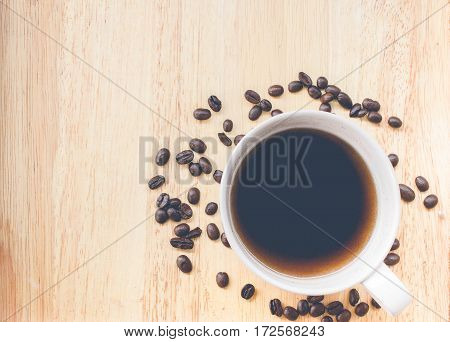 coffee bean and coffee mug on wood background