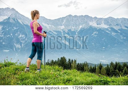Young woman without backpack hiking in the mountains Alps. Austria. Insbruk