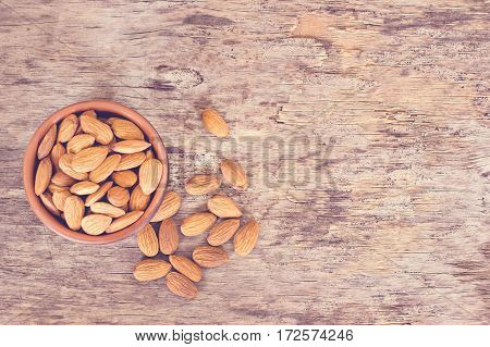 Almond. Almonds in a bowl on the old wooden background.