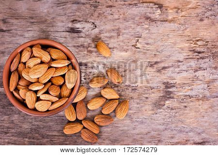 Almond. Almonds in a bowl on the old wooden background.