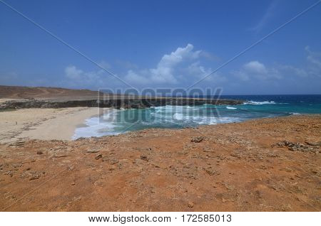 Aruba's Daimari beach with waves crashing ashore.