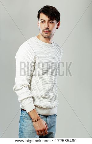 portrait of young handsome man posing in studio