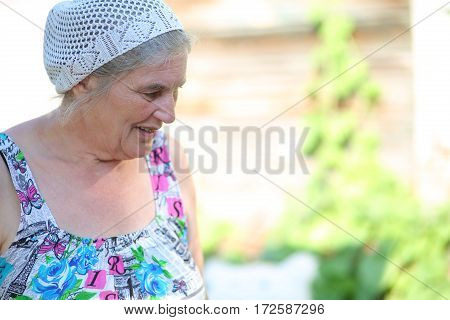 an elderly woman in the garden outdoors in dress