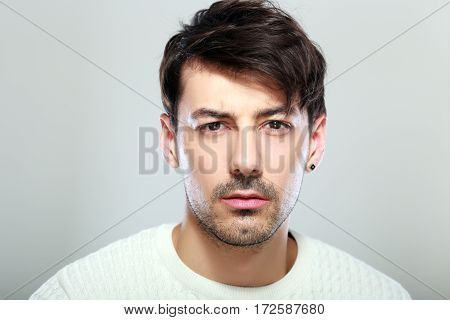 handsome young man face close up portrait look serious
