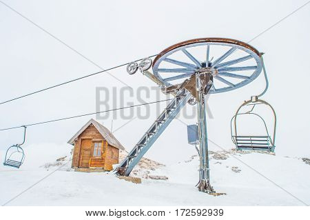 Cable car, wooden cottage and snow in Montenegro