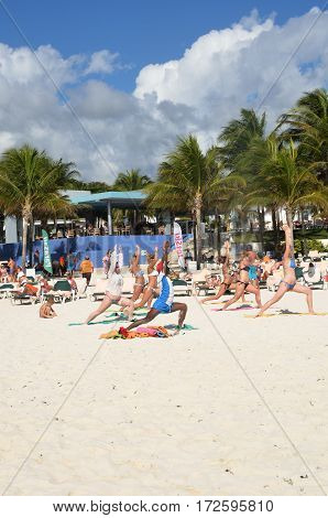 Playa del Carmen Mexico - January 28 2017: Holidaymakers in keep fit exercise class on caribbean beach