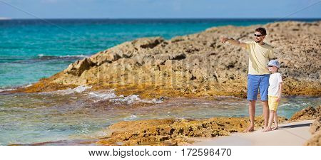 happy family of two father and son enjoying summer vacation together at perfect caribbean beach