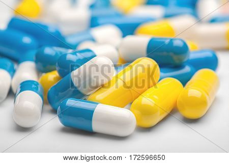Pile Of Medical Pills And Blue Pills On A Background