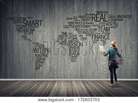 Female construction worker in room and globalization concept