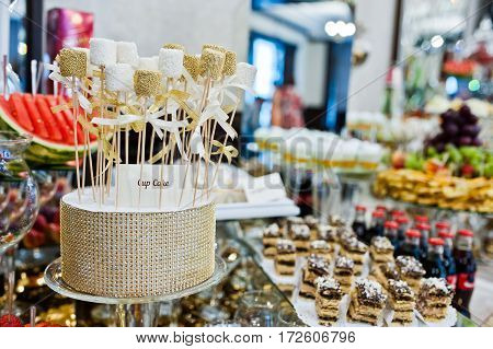 Different Swets And Cup Cakes At Wedding Reception.