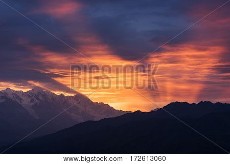 Mountain landscape at dawn. Beautiful sky with sunbeams and clouds. View from Mount Mkheer. Zemo Svaneti, Georgia 