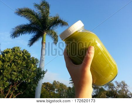 Mason jar of tropical green juice cleanse for health and healing