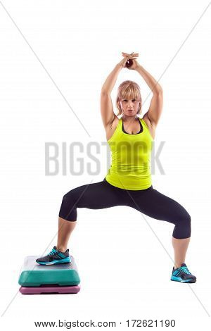 Beautiful Blond Young Woman Performing Step Aerobics Exercise
