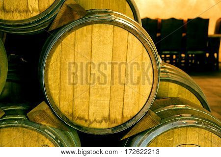 Wine Barrels Stacked In The Old Cellar Of The Winery.