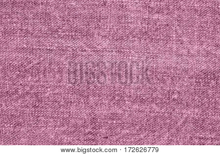 Homespun hemp cloth. Close-up of texture fabric cloth textile background. Homespun hemp fabric material. Homespun hemp canvas. Natural authentic cloth. Dusty pink color