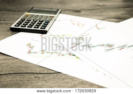 calculator on graffica the Dow Jones on forex market at grey table