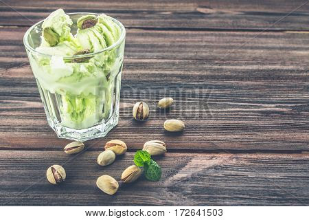 Ice Cream With Pistachios In A Glass On A Wooden Background