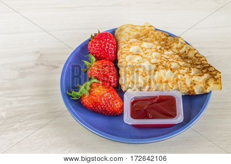 Pancakes With Strawberries On A Wooden Background