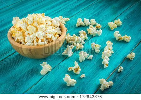 Popcorn In Wooden Plate On A Blue Background