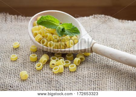 Pasta Rings On Sacking On Wooden Background