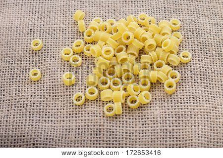 Pasta Rings On Sacking On Wooden Background