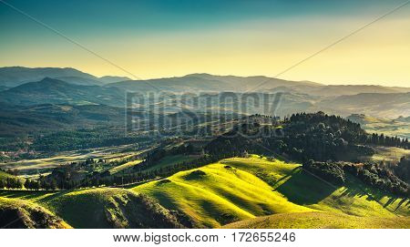 Volterra winter panorama rolling hills meadows and green fields on sunset. Tuscany Italy Europe