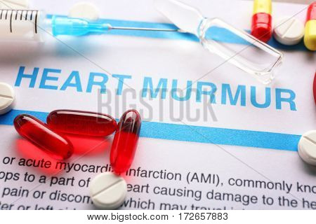 Diagnosis HEART MURMUR on medical report and medicines closeup
