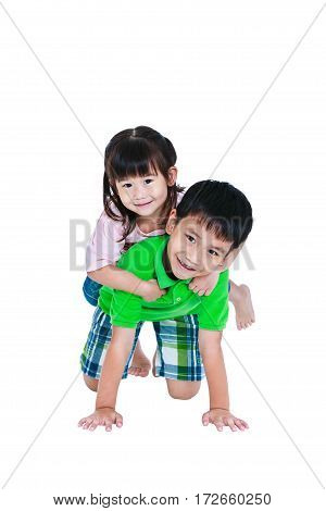 Asian kindly brother with his sister on piggyback ride and smiling happily isolated on white background. Concept about loving and bonding of sibling. Happy family spending time together. Studio shot.