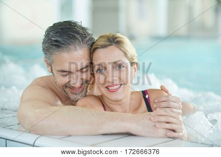 Couple relaxing in thalassotherapy hot tub