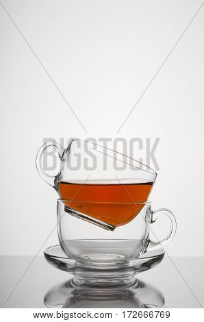 Two transparent glass cup with tea on white background