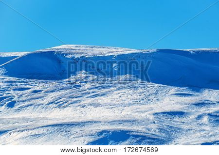 Evening winter mountains panorama of scenic view of snow on tops of rocks and pine forest