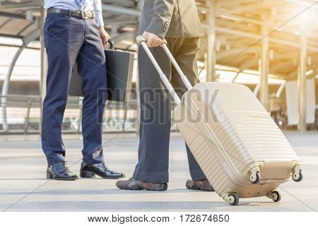 Businessman traveler with luggage at city background