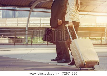 Businessman and businesswoman traveler with luggage at city background Business People Commuter Walking City Life Concept.