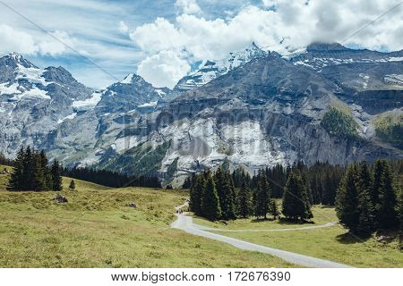 The road to the picturesque glacial lakes Oeschinensee. Popular tourist attraction. Gorgeous scene. Location Swiss alps, Kandersteg, Bernese Oberland, Europe. Instagram toning effect. Beauty world.