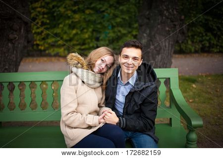 Young Boy And Girl Hugging And Kissing, Sitting On The Bench