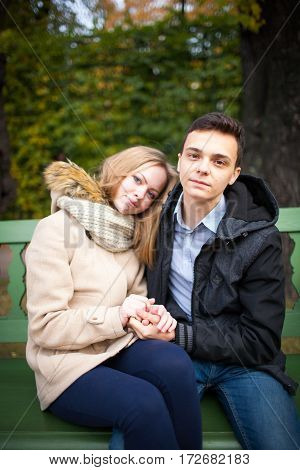 Young Boy And Girl Hugging And Kissing, Sitting On The Bench